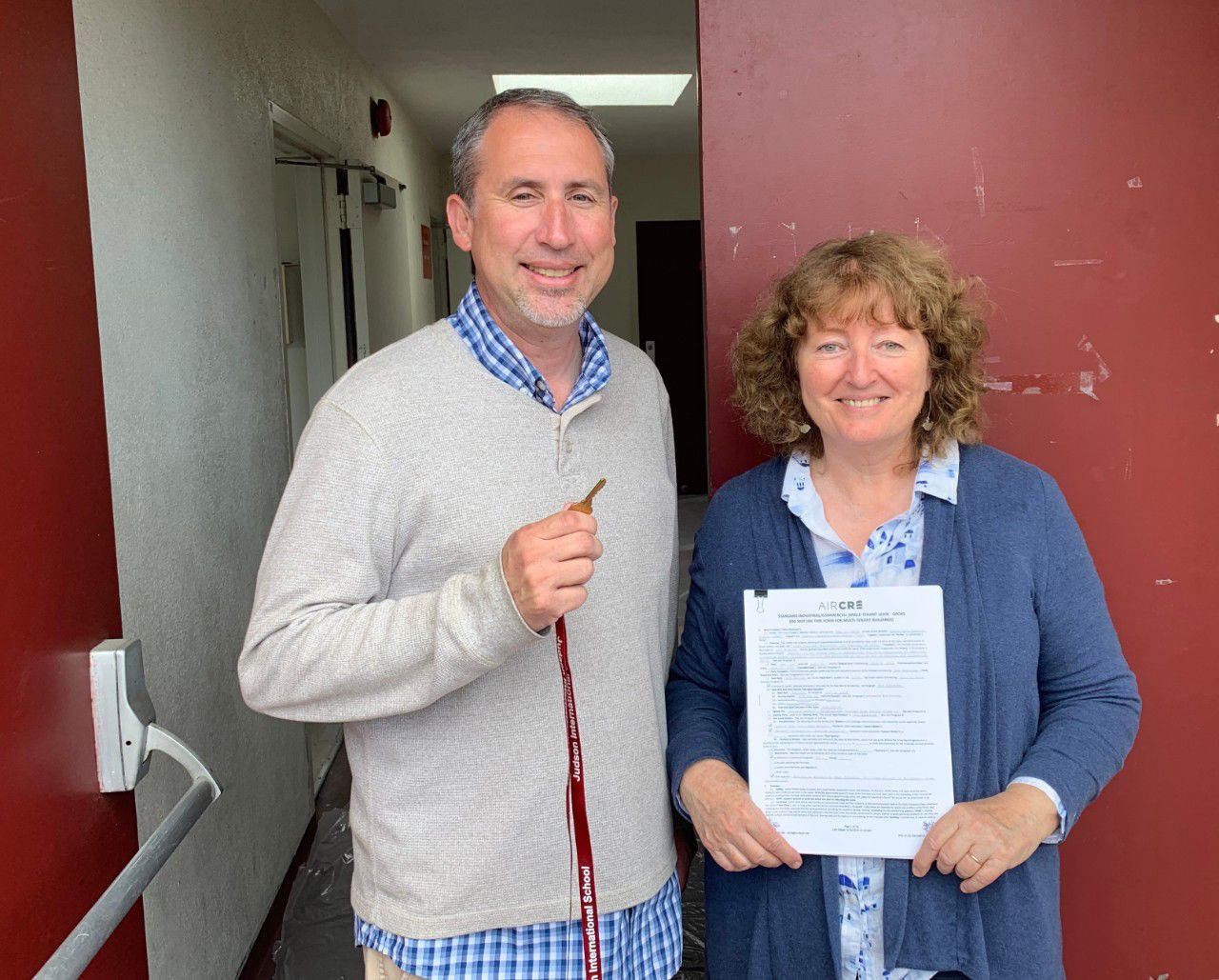 Michael Jarrard, Dean of Students and Diana Bjoraker, Principal with keys and lease in hand (1).jpg